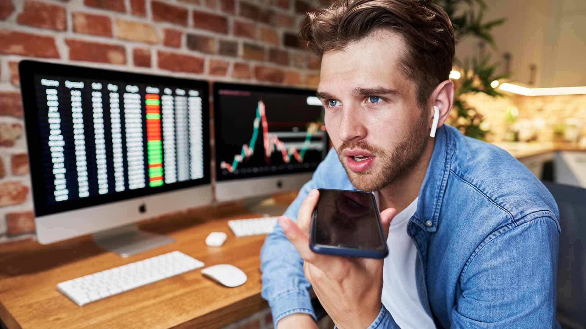 Photo of a financial investor using his phone for business